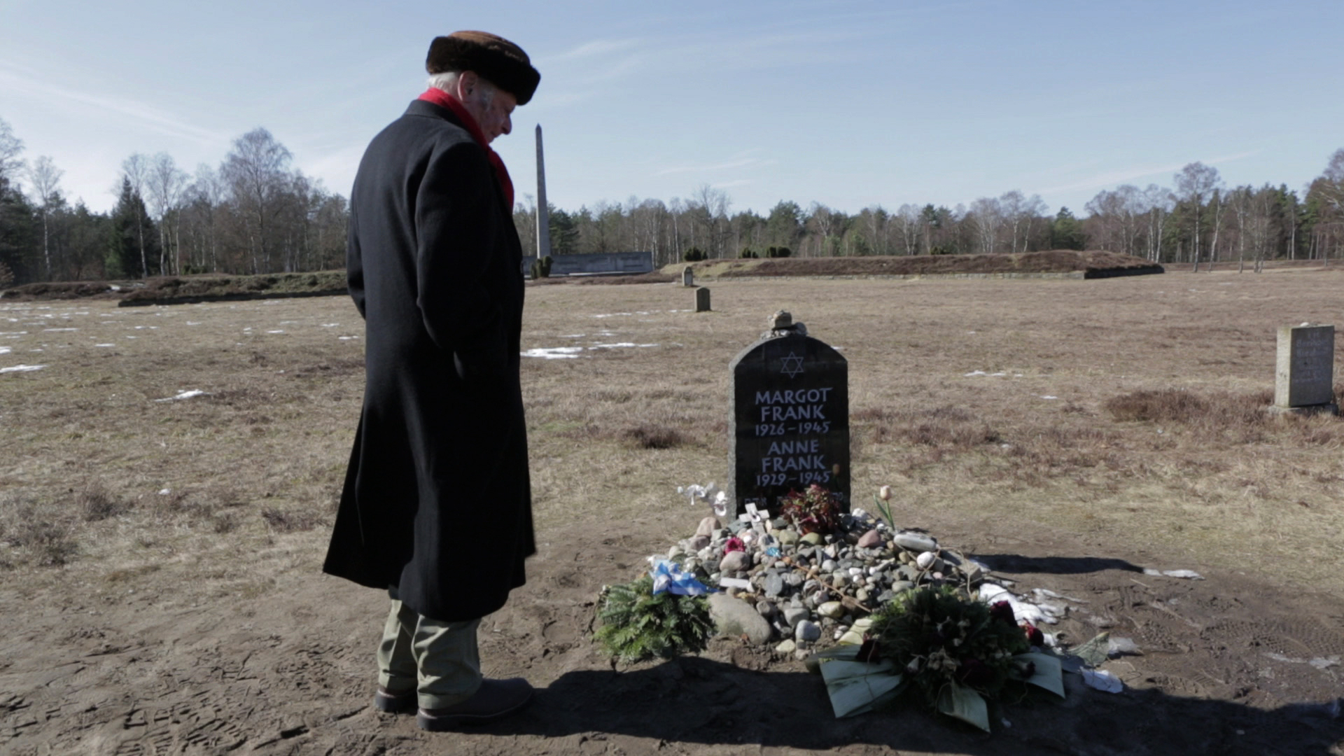 Buddy Elias viisting the memorial grave site of his cousin, Anne Frank at Bergen Belsen Camp.