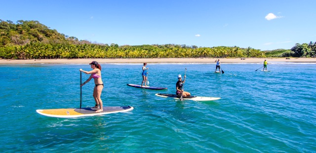 Stand up paddle boarding in the ocean on Vajra Sol's retreat.