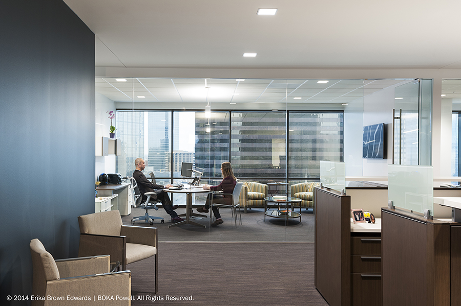 Floor-to-ceiling windows offer sweeping views of the Dallas skyline from one side of the office to the other.