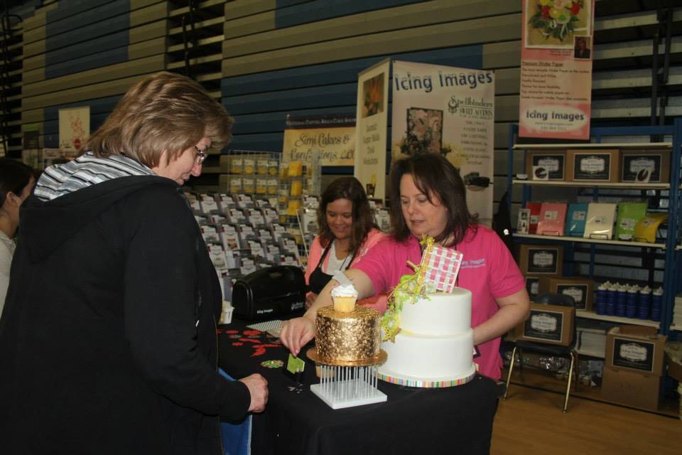 Deborah Coughlin assists a customer at the show booth