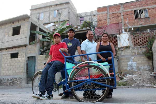 From left: Jorge, Cesar, Julio and Alicia stand next to the family’s food cart in Mexico.
