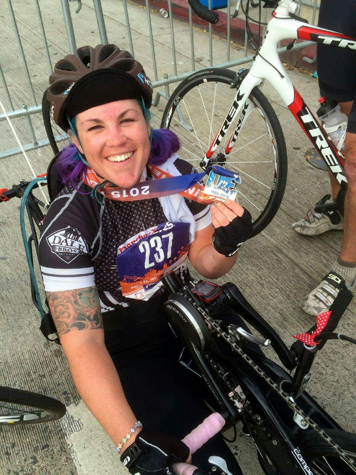 Loma Linda University Health PossAbilities member Jenna Rollman, 28, shows off her first place medal after competing in the 2015 Asics LA Marathon hand cycling race on Sunday, March 15.