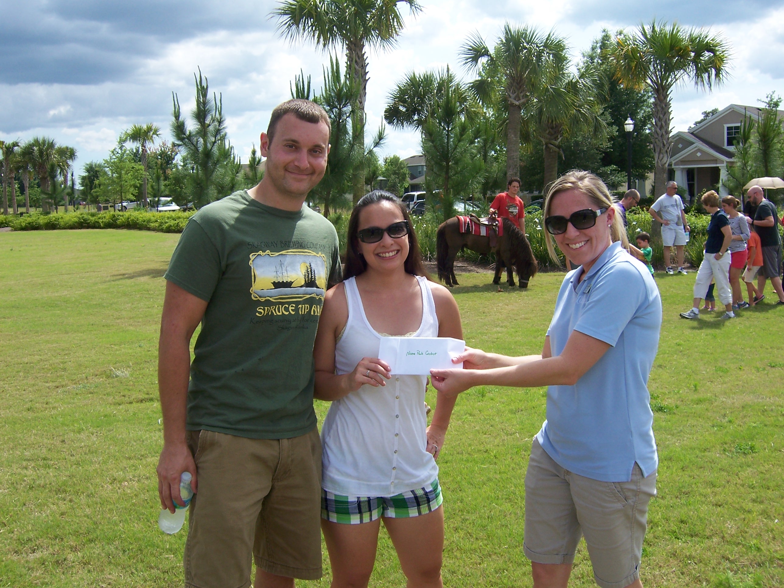 Club Connerton's Amy Gallogly with 'name the park' winners Jeremy & Maya Cohen