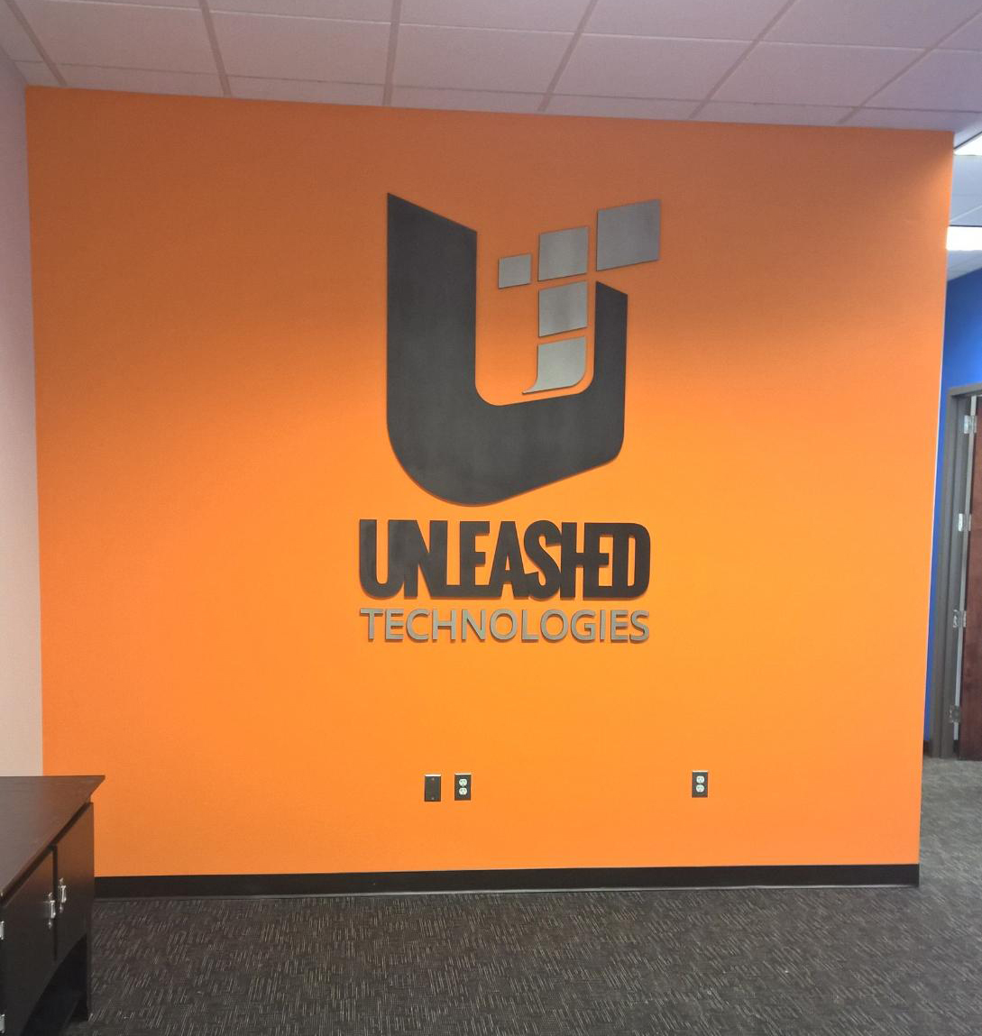Logo prominently displayed at the entry for the new headquarters.