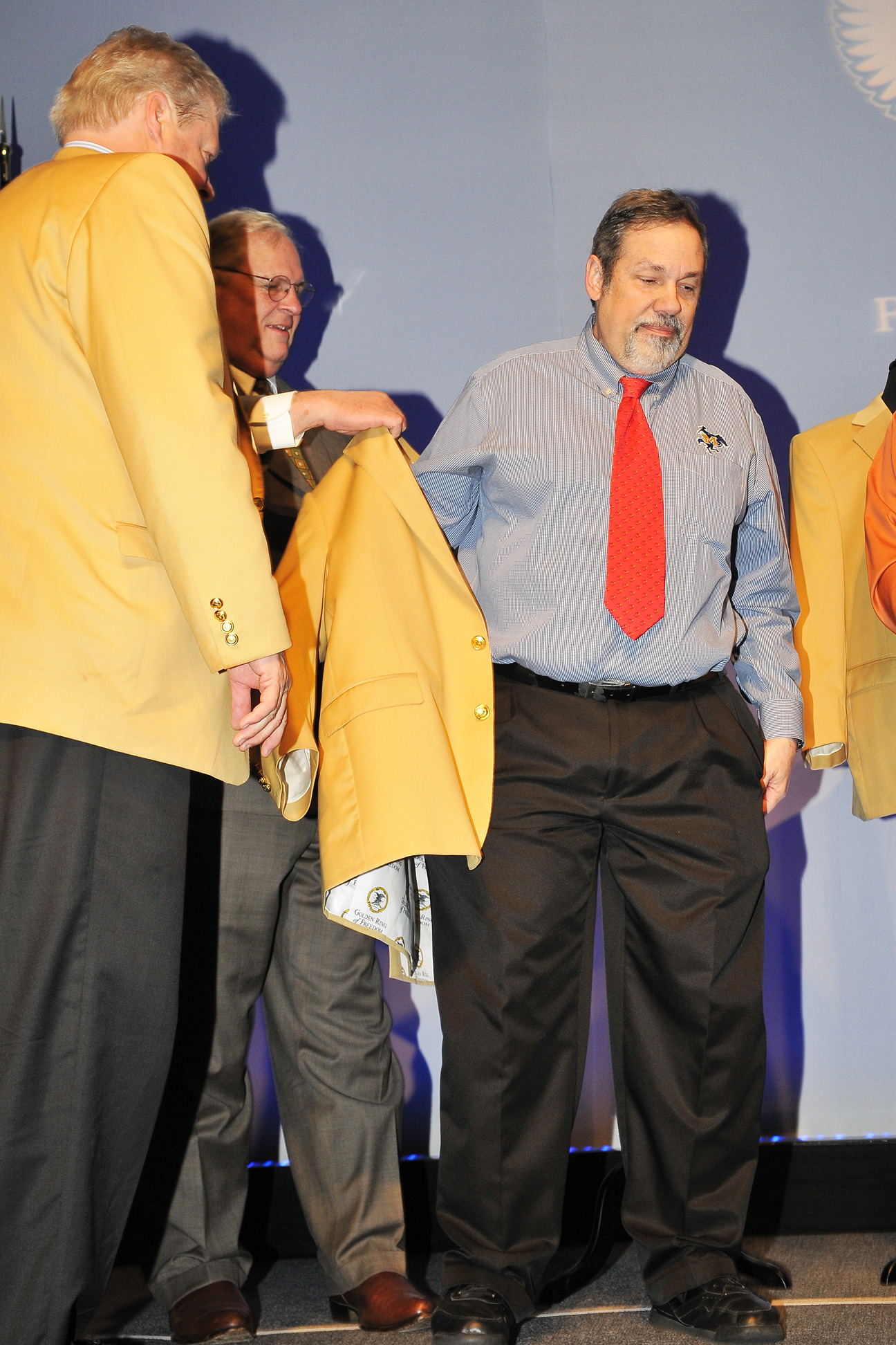 Michael Fuljenz receives his custom-tailored gold jacket at his induction into the NRA Golden Ring of Freedom society in Nashville, Tennessee on April 10, 2015.  (Photo by Jerry Jordan.)