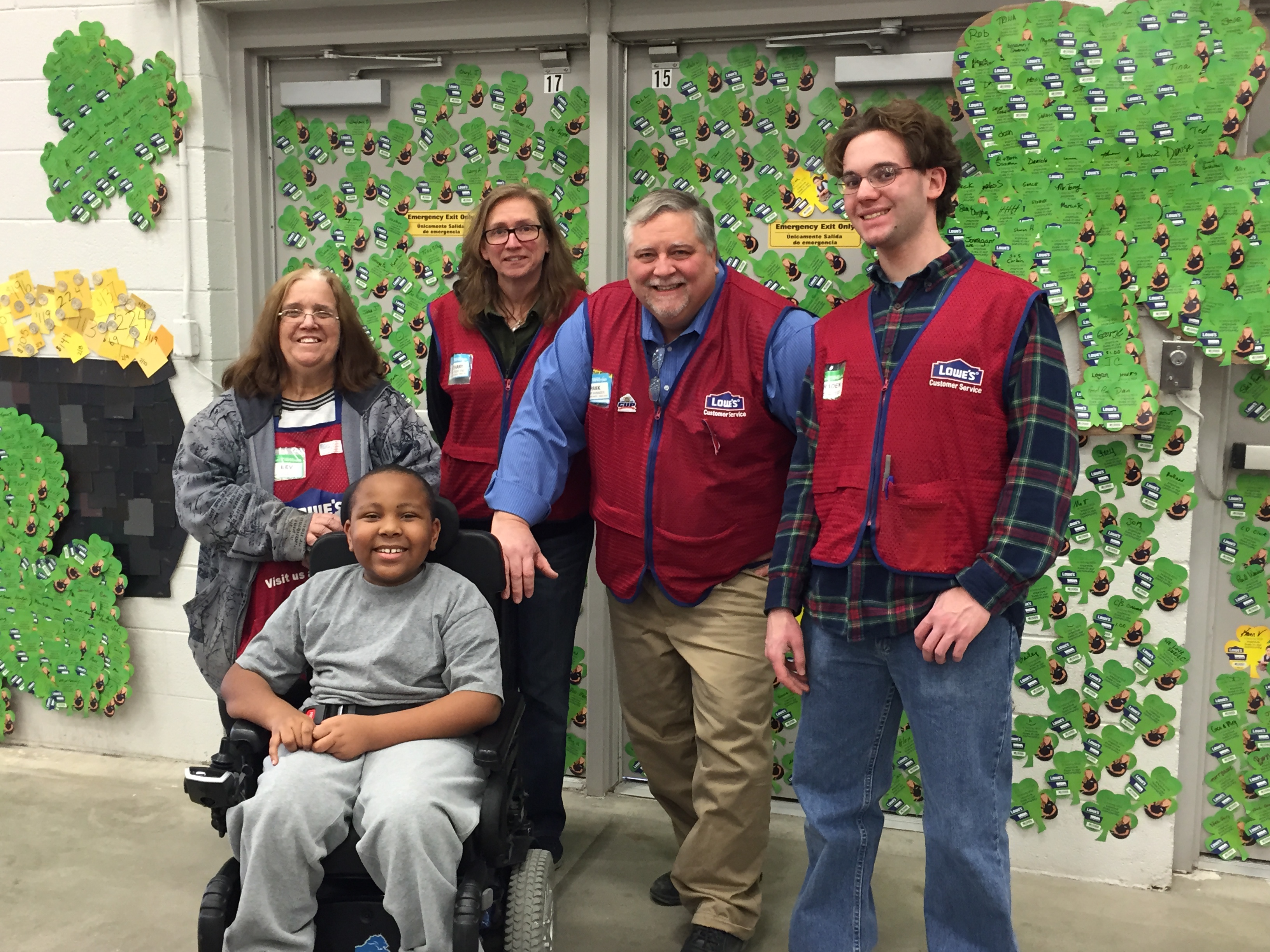 MDA Ambassador Torrance Johnson poses with employees from Lowe’s store 734 in Ypsilanti, Mich. in front of their special MDA Shamrock display.