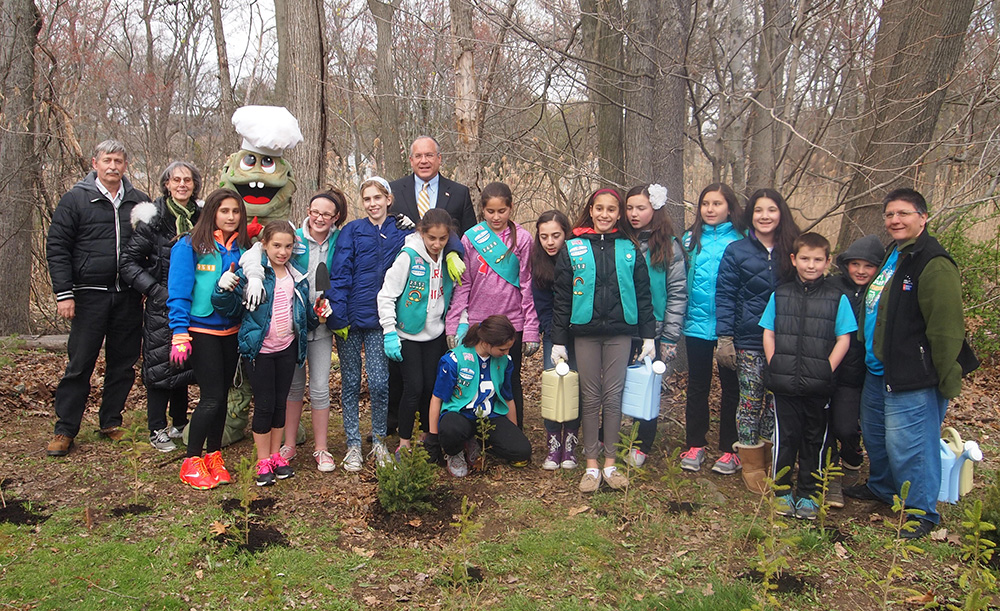 Almstead arborist Michael Marks (left) with Judith Blau (second from left) creator of Treetures, Eastchester’s town supervisor, Anthony S. Colavita (middle) and local Girl Scouts at the Magic Treeture