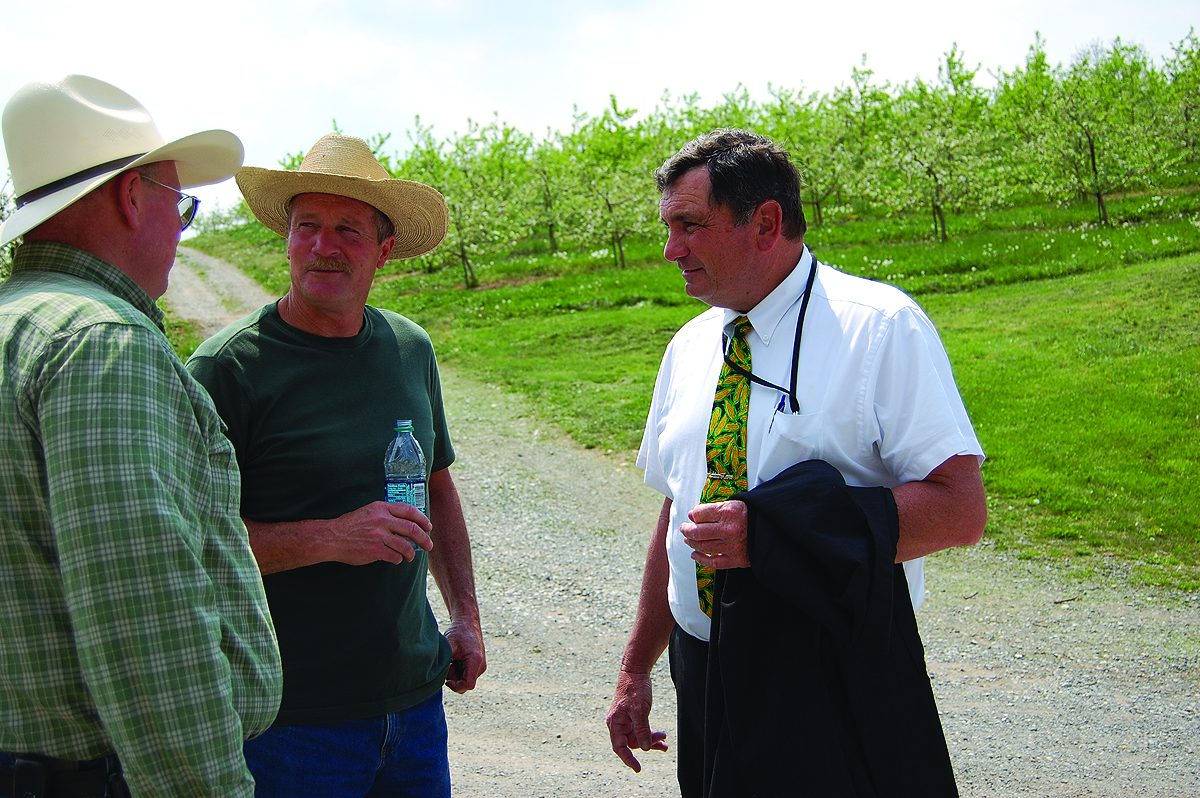 Steve Ernst, the first farmer certified under the FSCAP program congratulates Bill Gardenhour alongside Maryland Secretary of Agriculture Joe Bartenfelder.