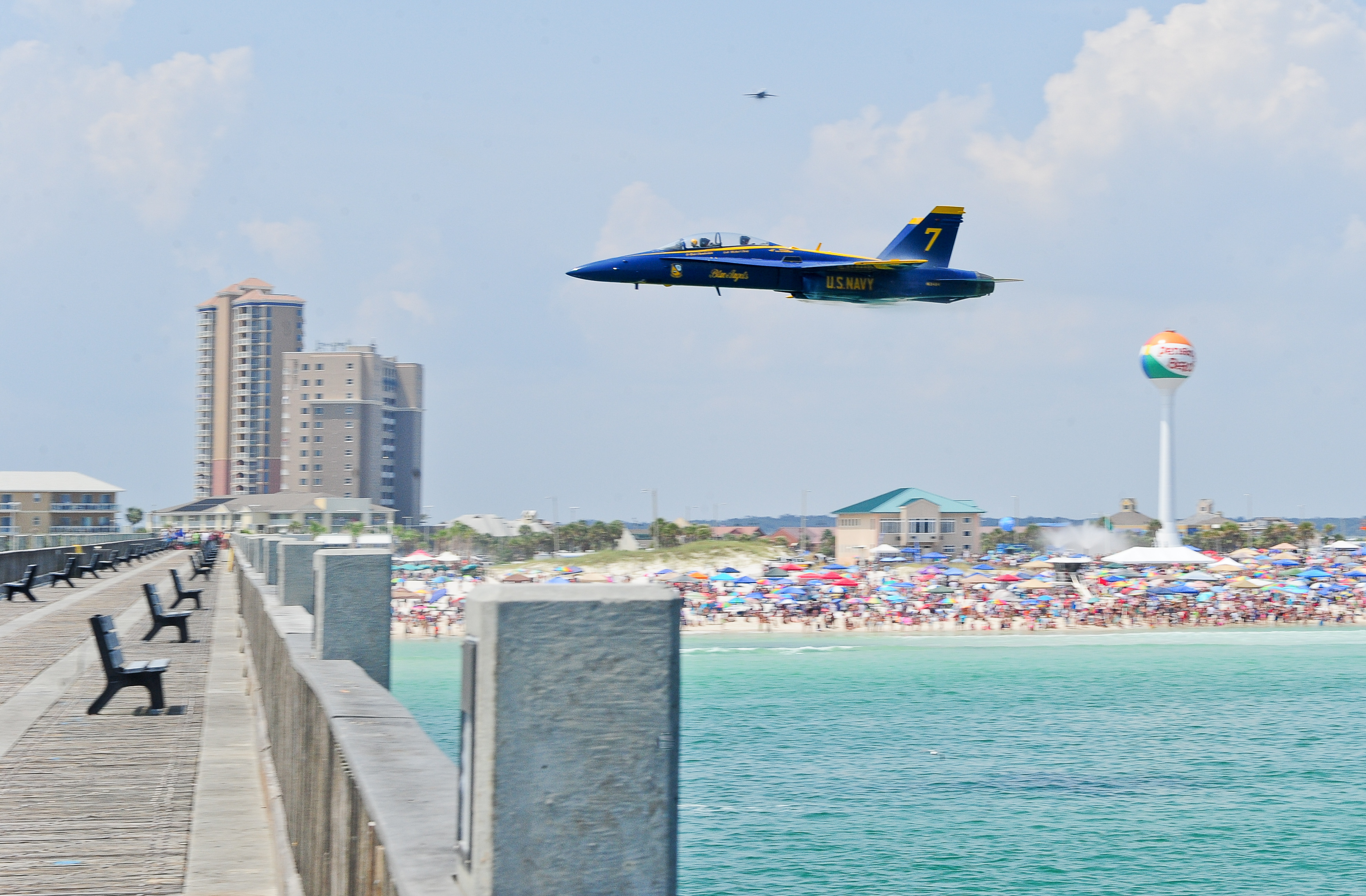 A Blue Angels solo pilot makes a high speed pass over the Pensacola Beach Gulf Pier, wowing thousands of spectators, during the Pensacola Beach Air Show.