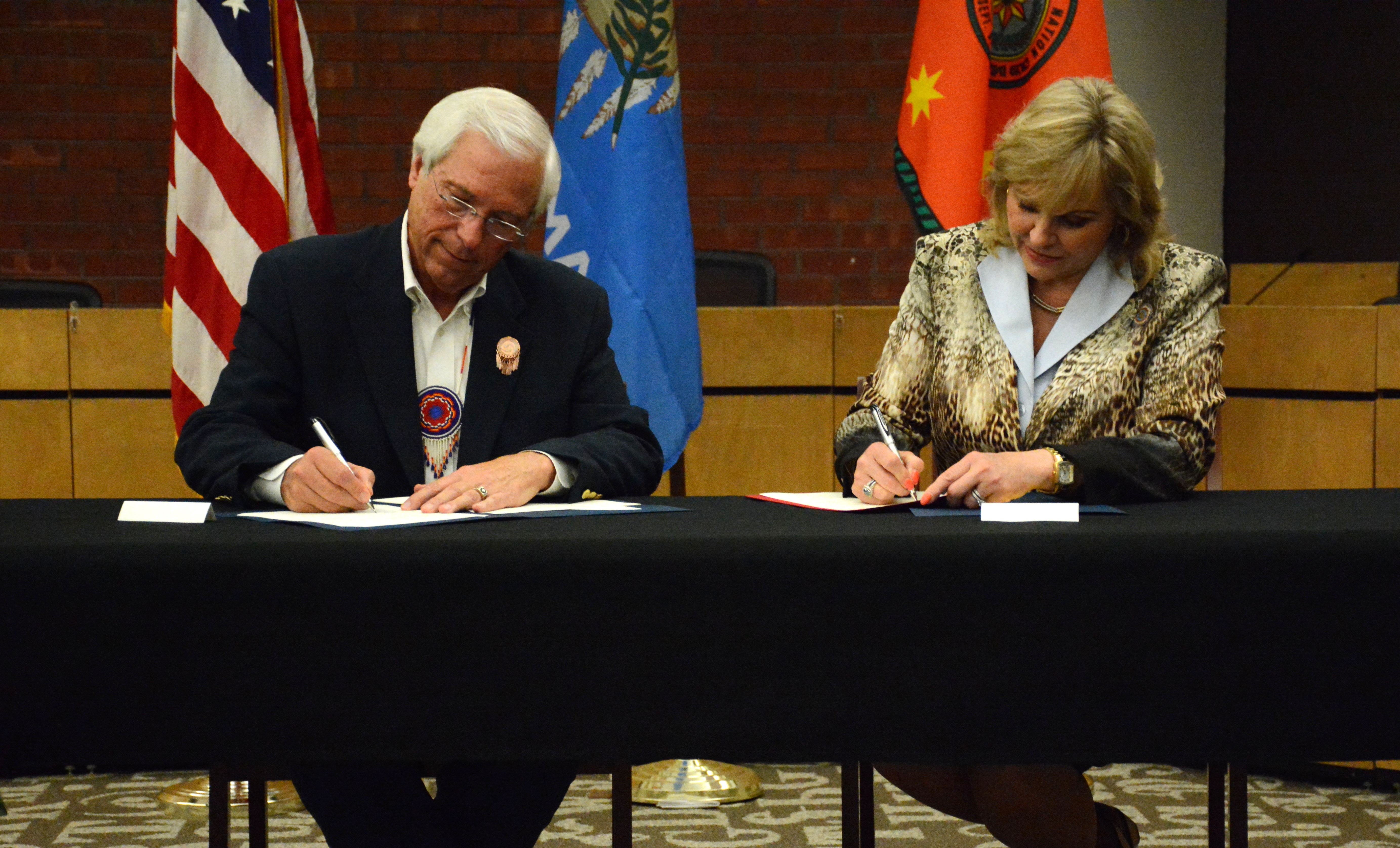 Cherokee Nation Principal Chief Bill John Baker and Oklahoma Gov. Mary Fallin sign a hunting and fishing compact that expands the hunting and fishing rights of all Cherokees living in the state.