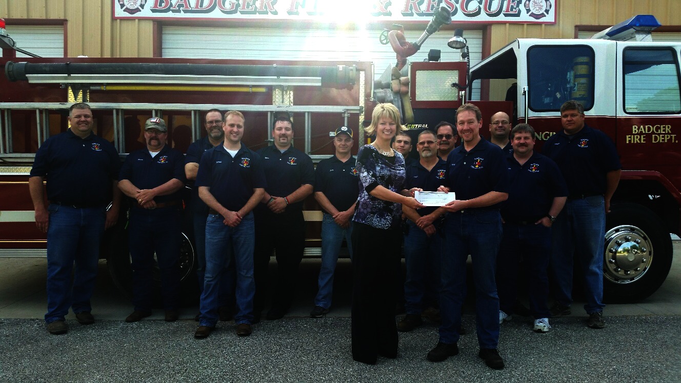 Marcie Boerner, WCCTA Office Manager handing Troy Martens the $5,000 donated to the Badger Fire and Rescue