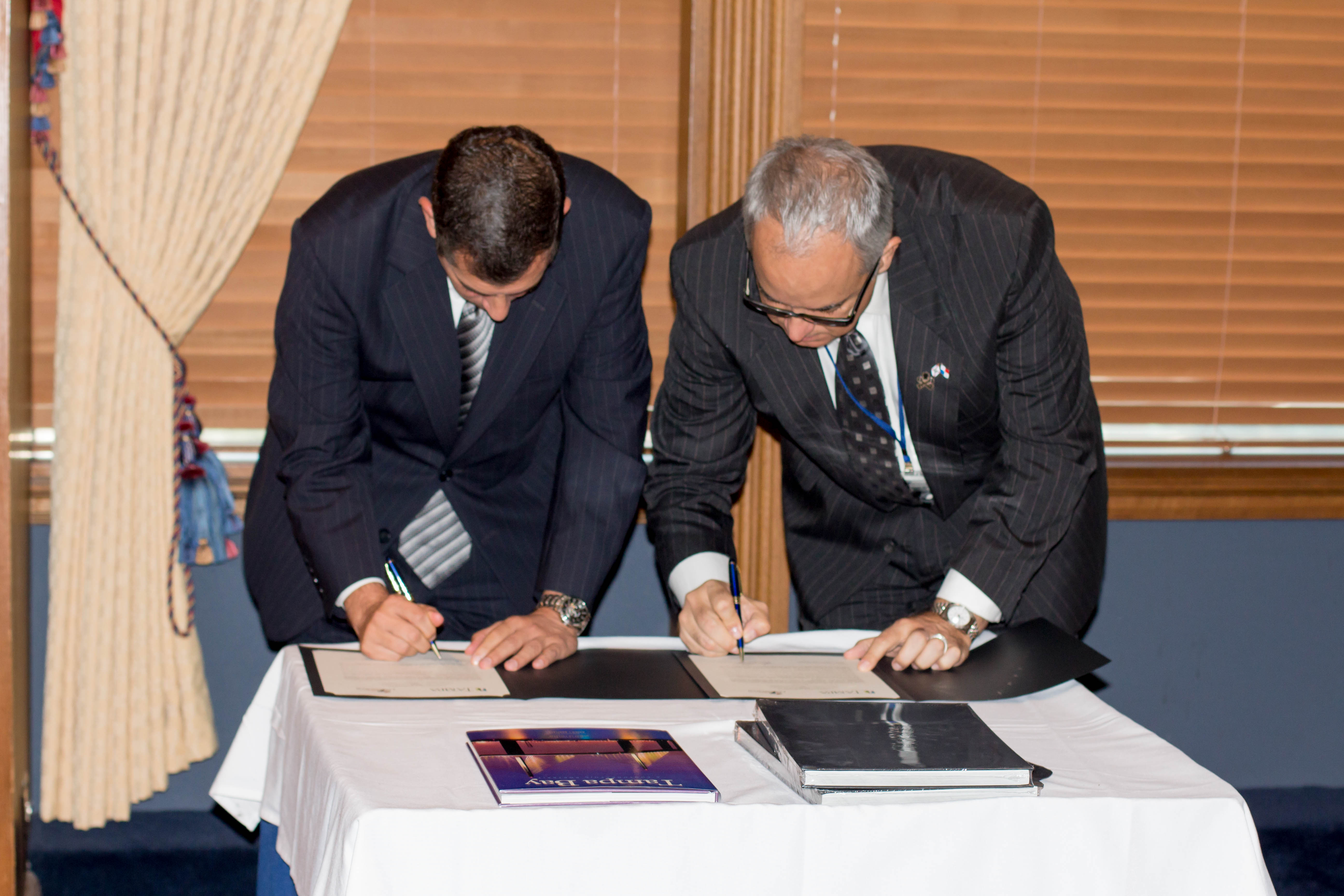 Ronald Christaldi, Shumaker attorney and Greater Tampa Chamber of Commerce chair, and Robert St. John, president of the American Chamber of Commerce Panama, signing the historic memorandum of understa