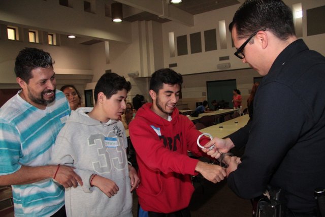 What do handcuffs feel like? Volunteers can try them on to find out at a BE SAFE Interactive Screening