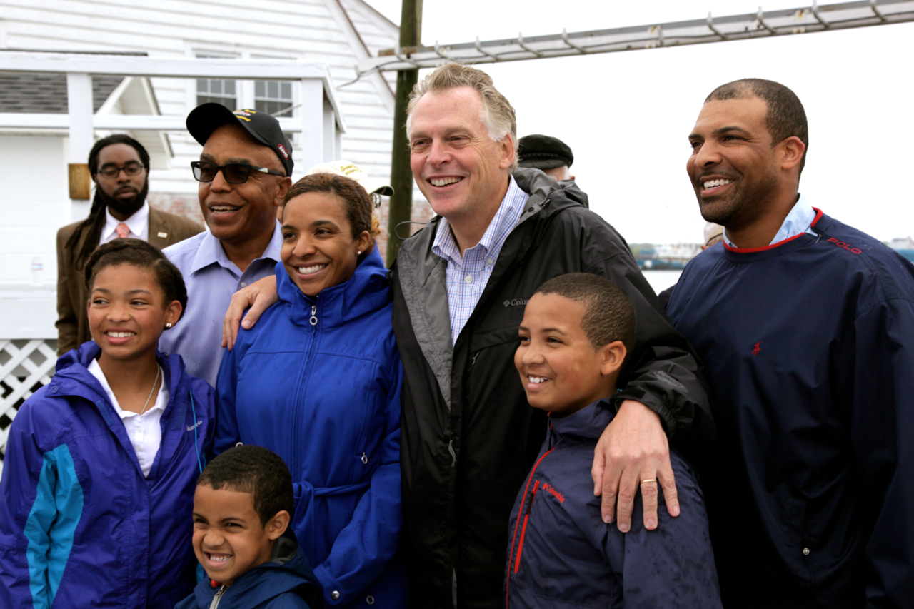 Gov. Terry McAuliffe poses with Phillip Haynie, a local community and business leader and close colleague to Omega Protein, and family in Reedville, Va.