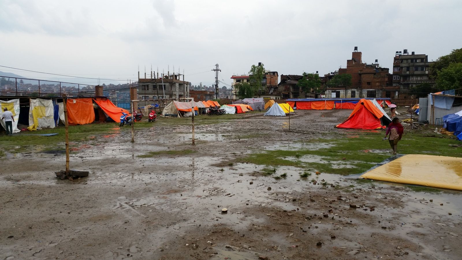 In this suburb of Kathmandu, nearly all of the buildings were destroyed by the original temblor in Nepal. The school’s football field is being transformed into a tent city.