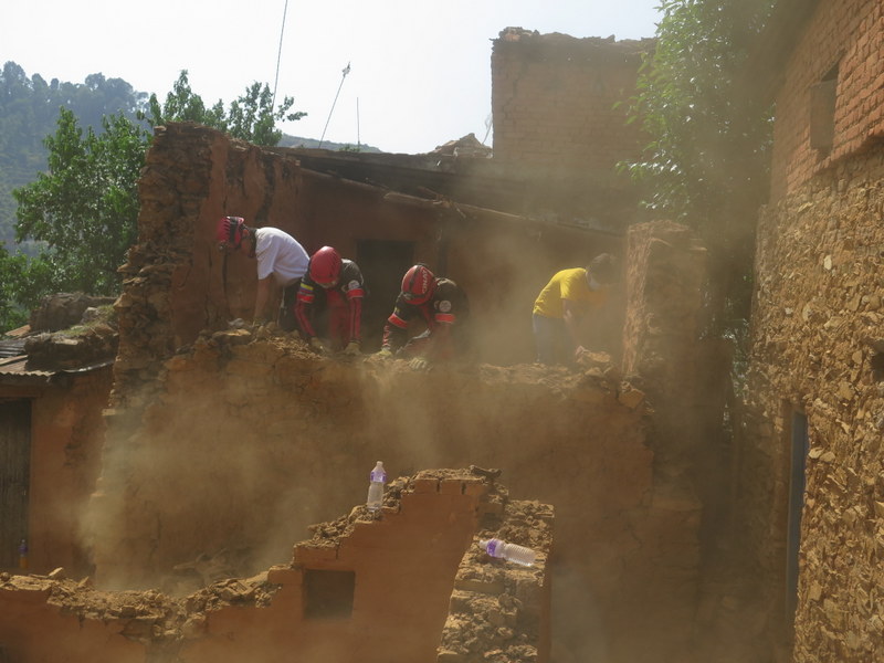 CINAT members and Volunteer Ministers work together to demolish the temple walls left severely damaged by the series of earthquakes and aftershocks in Kathmandu, Nepal.
