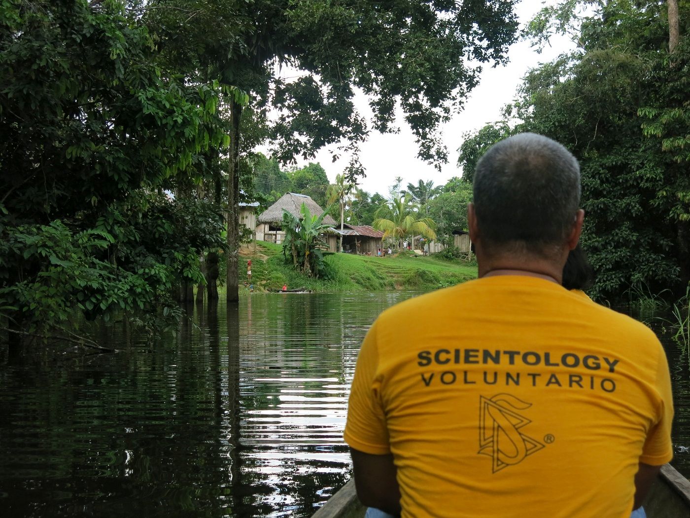 A Scientology Volunteer Minister on the Amazon Goodwill Tour travels by boat down the river in May to introduce a remote village to technology it can use to improve conditions for the community.
