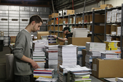 Employees at the ProLiteracy warehouse prepare New Readers Press books for shipment.