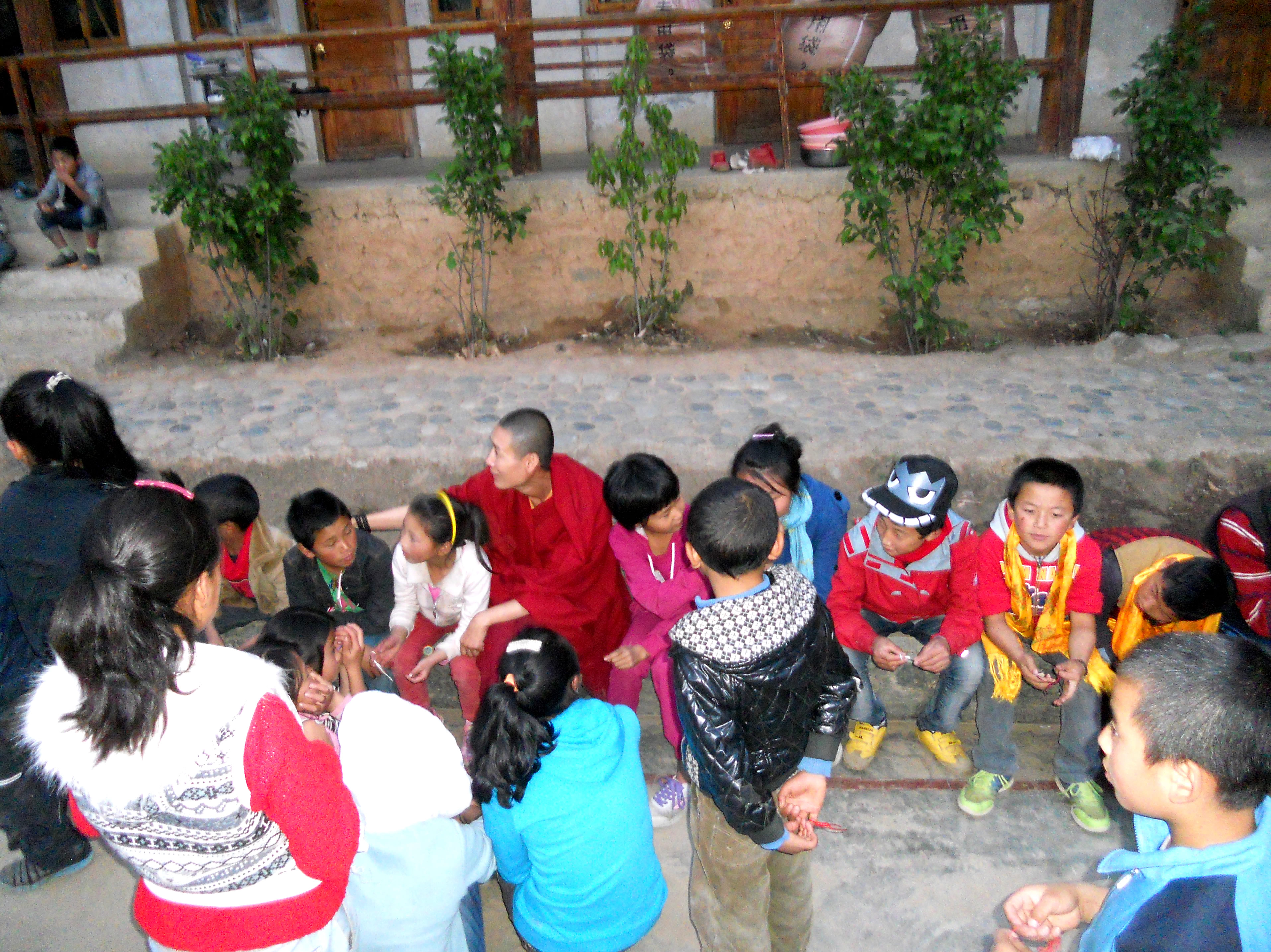 Students sitting with Principal Li, a buddhist nun who runs the school.