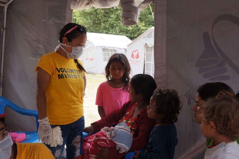 In a temporary medical tent in Nepal, a nurse—a Scientology Volunteer Minister, brought to Nepal from Australia by the International Association of Scientologists.