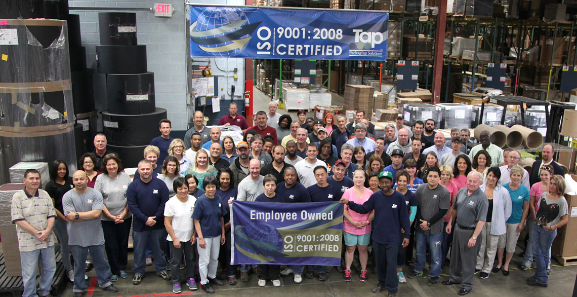 Employees of Tap Packaging Solutions proudly showcase employee-ownership and ISO 9001:2008 certification