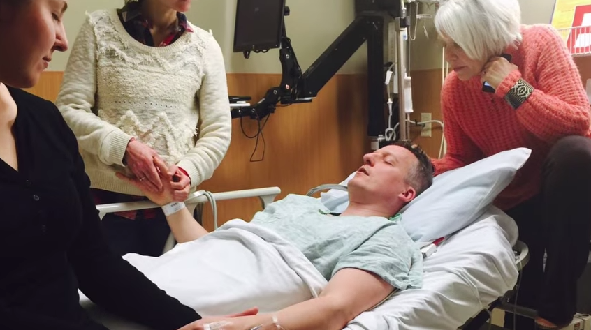 Andrew and his family praying before his most recent surgery at University of Colorado Hospital, March 2015.