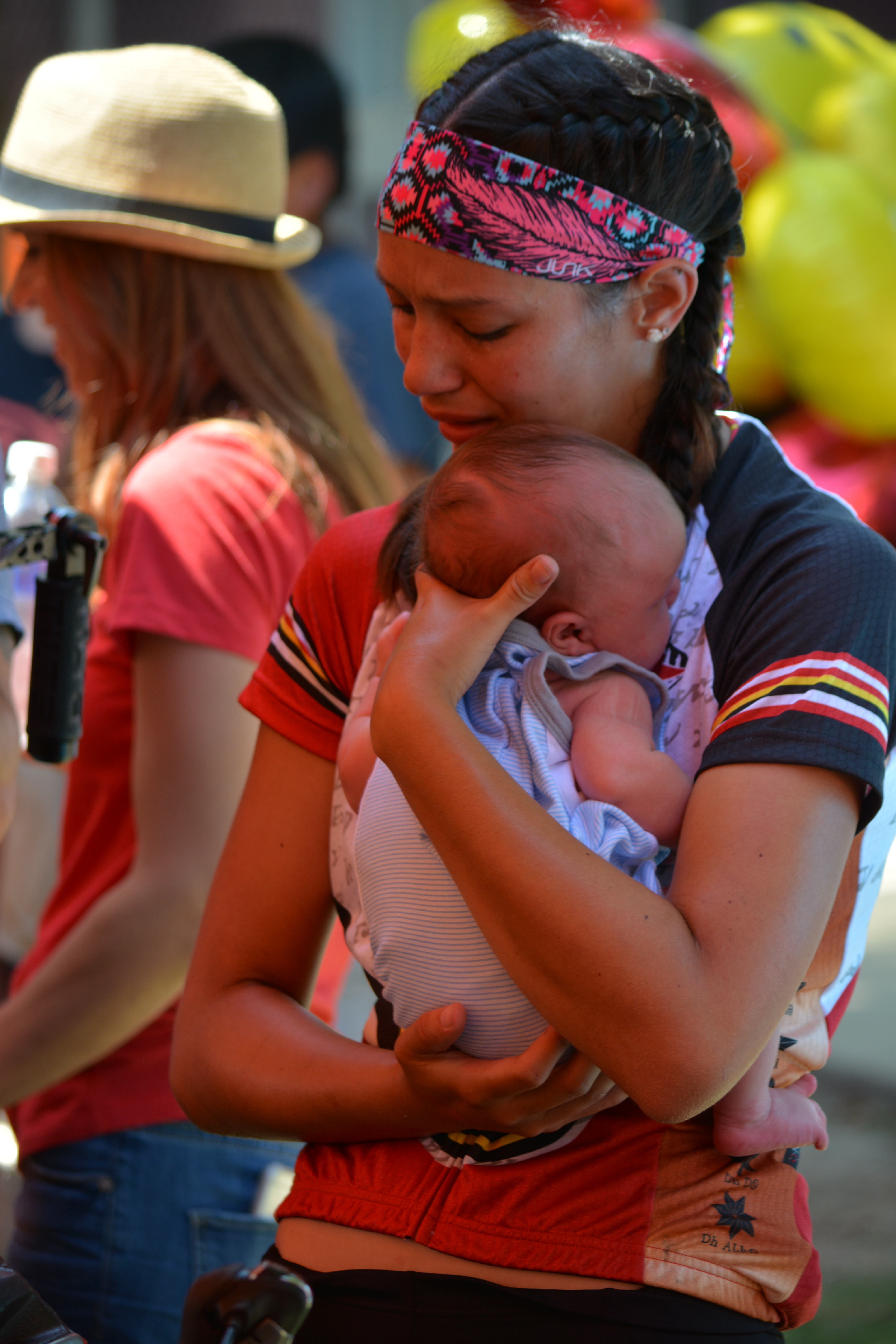 Cherokee Nation citizen and 2015 Remember the Removal rider Alexis Watt hugs her baby nephew Gunner Kirk after completing her nearly 1,000-mile ride with other riders Thursday.