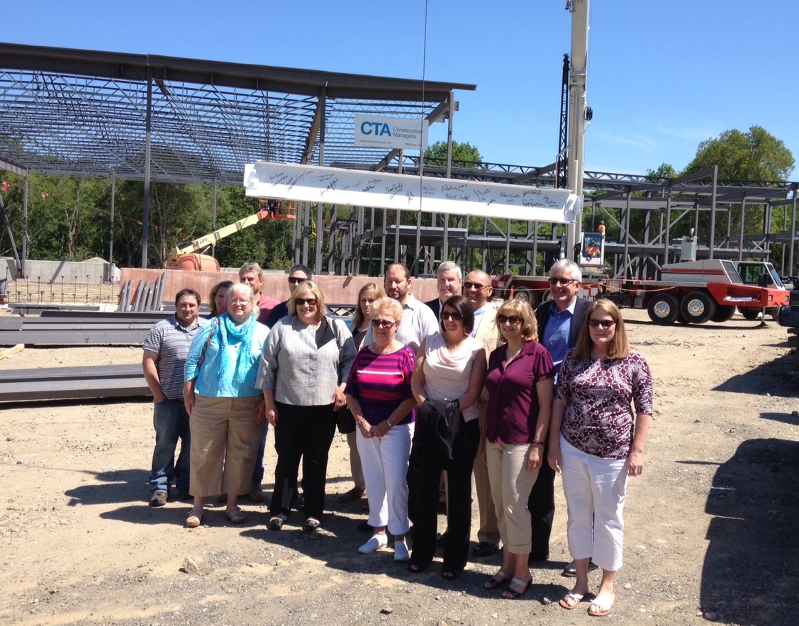 Hingham Municipal Lighting Plant employees recently joined CTA Construction for the topping-off ceremony at the site of its future headquarters on Bare Cove Park Road.