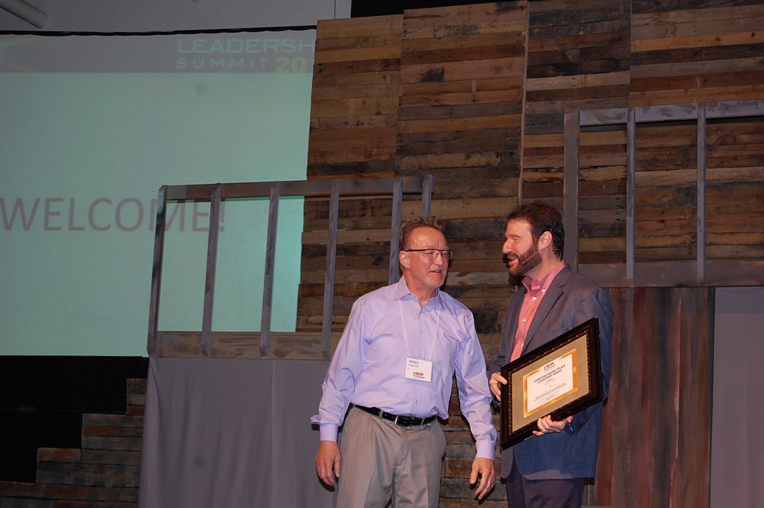 From left: Mike Wright recieves a Christian Marketplace Leadership award from AWOP president Chuck Proudfit.