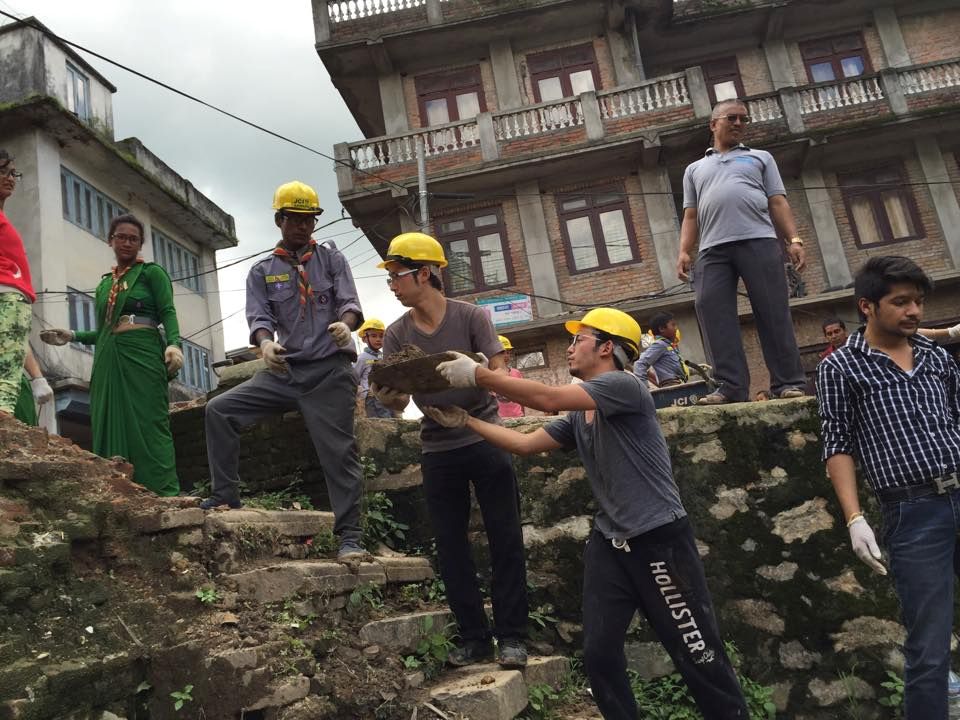 Nepali Scouts help chain rocks and other debris out of the sacred pond in Sankhu.