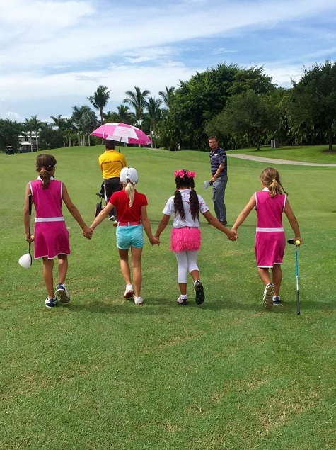 Girls aged 7-9 walk to the next hole on St. Andrews Country Club's Palmer Course as they compete for awards and prizes.