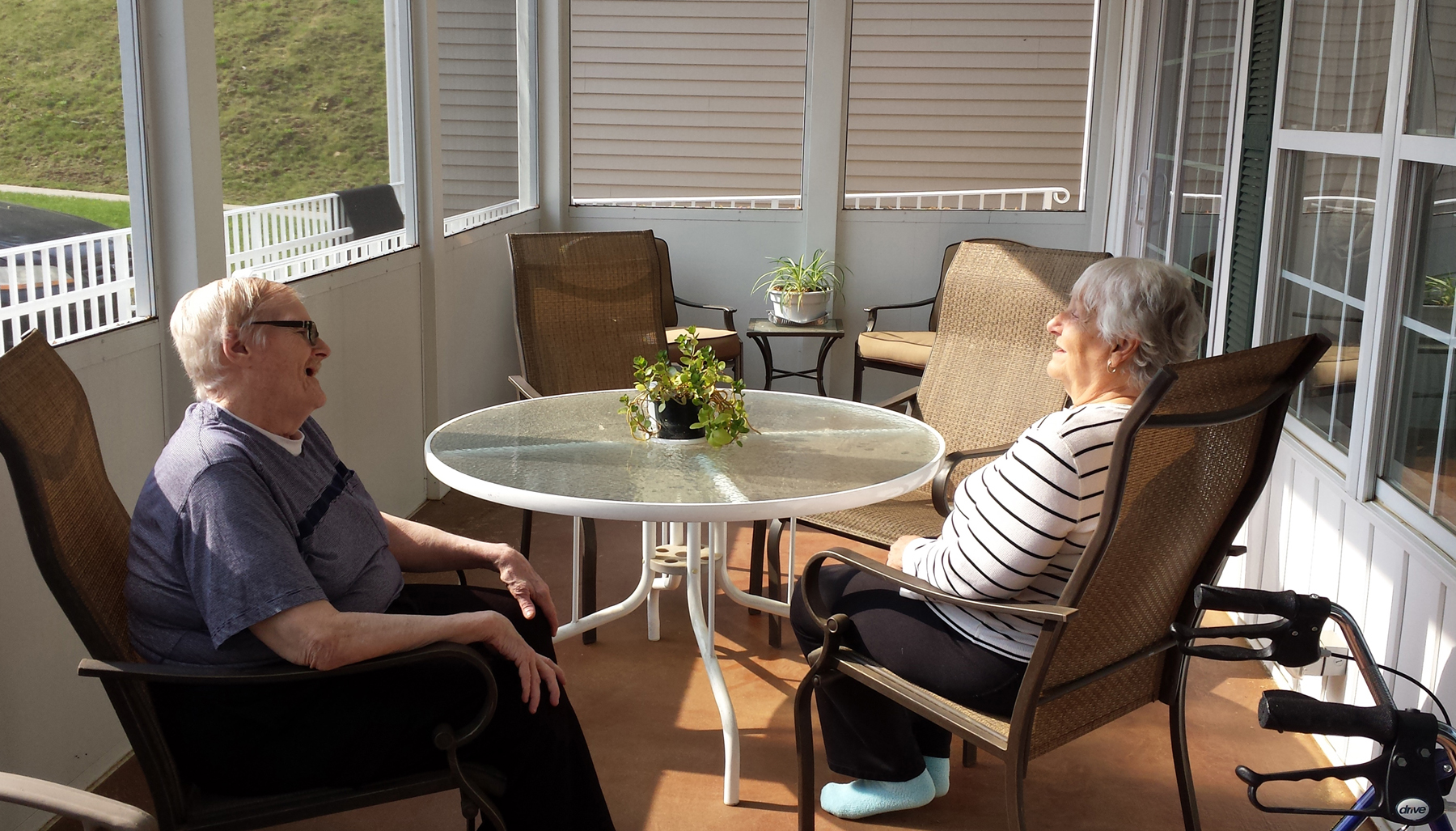 Senior residents at a CHC home in Warren Township relax on the porch, one of the shared common areas, in addition to their private bedroom and bathroom.