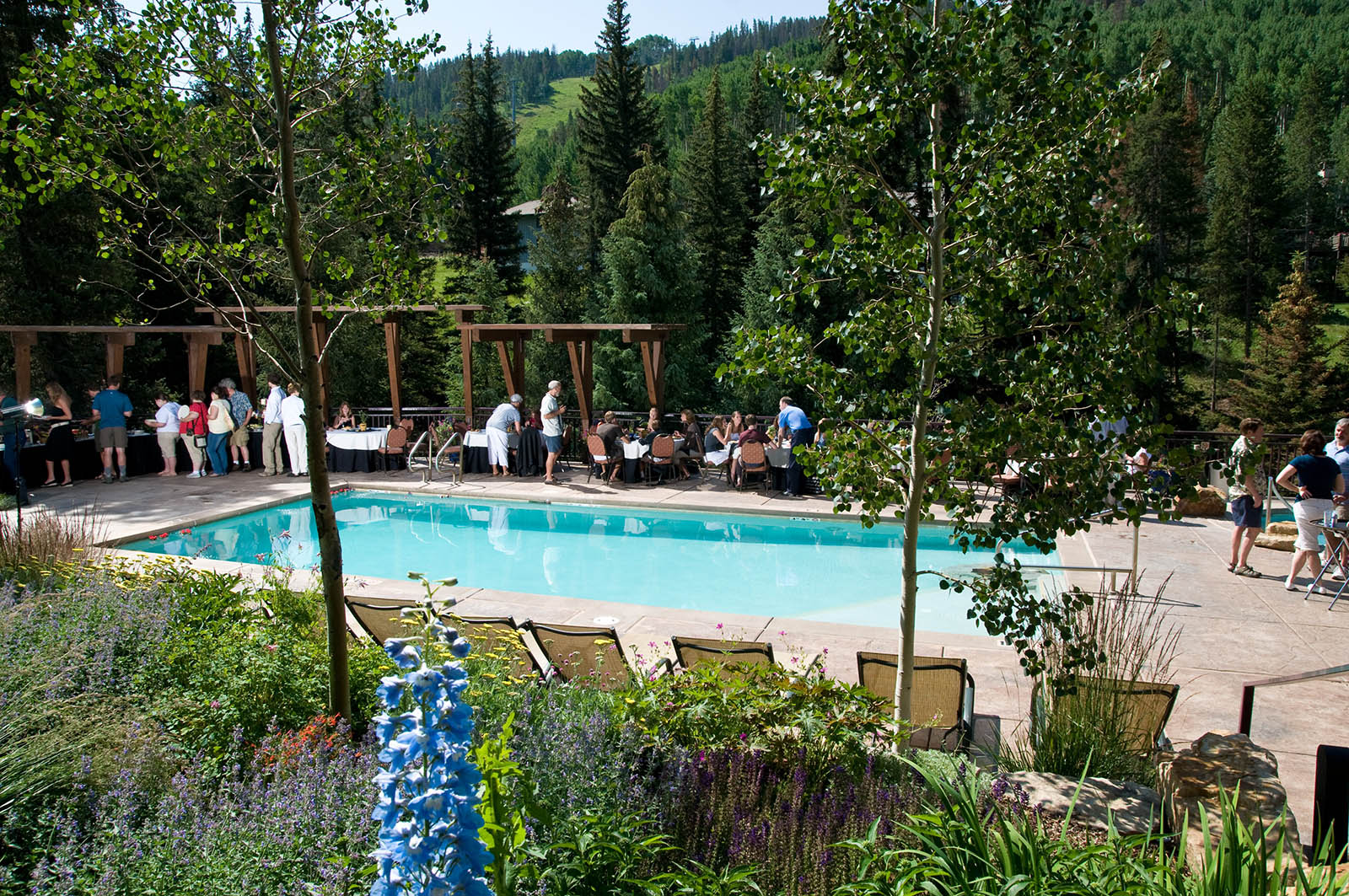 Antlers at Vail conference guests enjoy an outdoor buffet in the Vail hotel’s scenic outdoor pool setting overlooking Gore Creek.