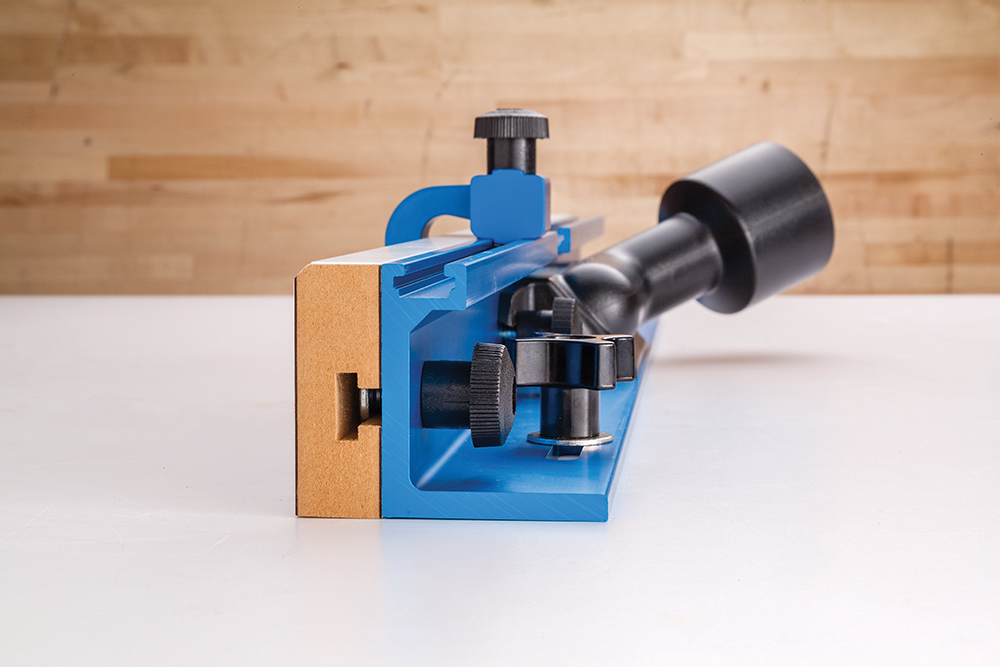 The side view of Rockler's new Drill Press Fence shows how the dust port is angled upward and off to the side, keeping dust collection components clear.