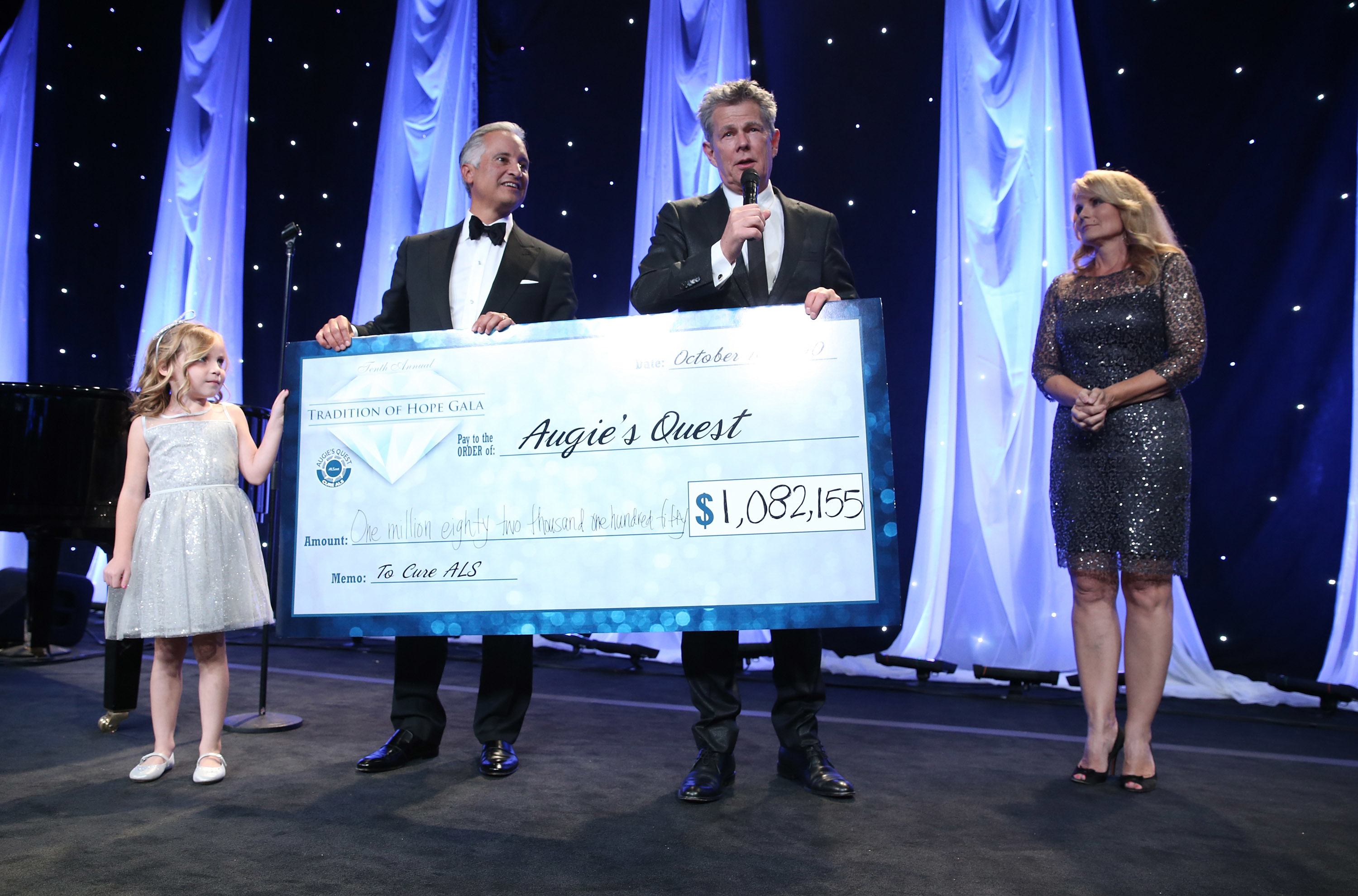 Augie’s Quest Tradition of Hope gala honoree, Bert Selva, went up on stage with David Foster and Jann Carl for the night’s check presentation. Photo credit Steve Cohn.
