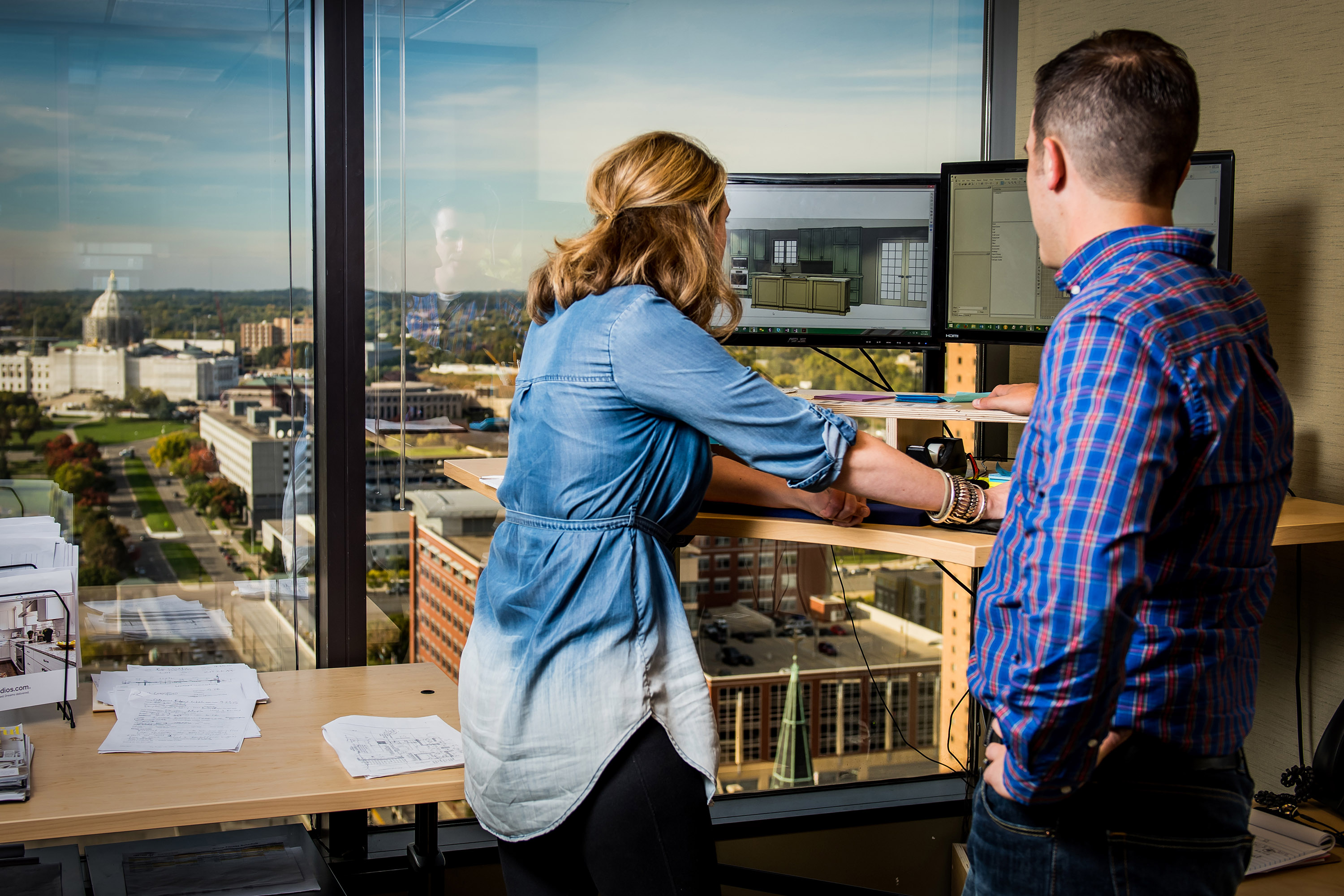 CliqStudios designers Kara Lepley and Mason Sellers collaborate on a client’s kitchen design at the new location in downtown St. Paul. The office is not open to the public, but designers may be reache