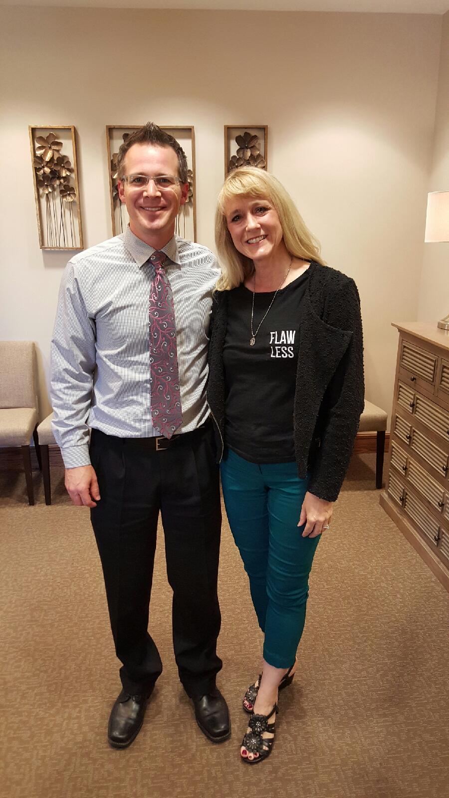 Kim wearing her Flawless shirt over her missing left breast with Dr. Mark Jensen in support of Ghost Boob Awareness after Mastectomy