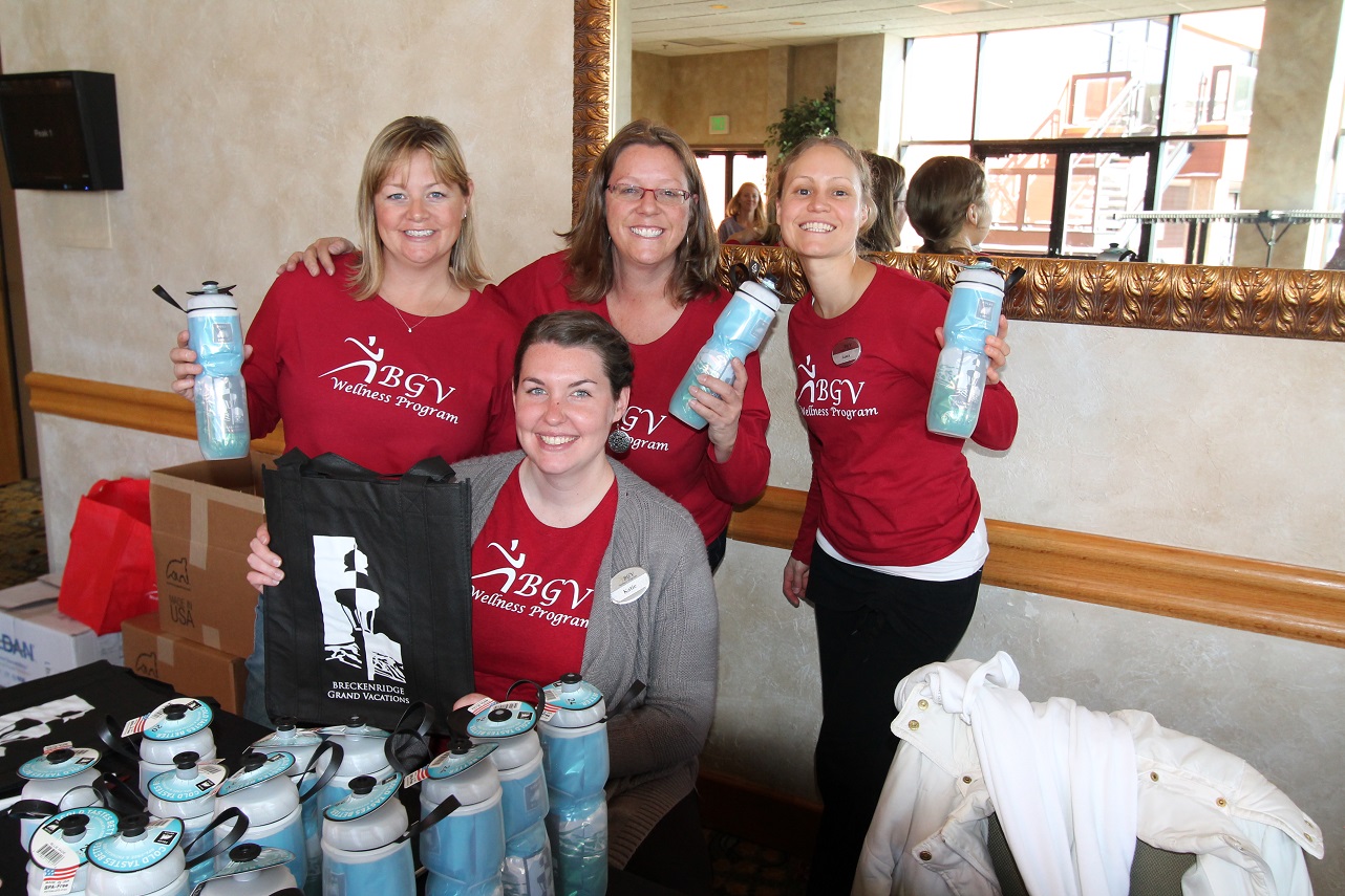 BGV Wellness Committee Members and volunteers greet attendees with smiles and custom water bottles.