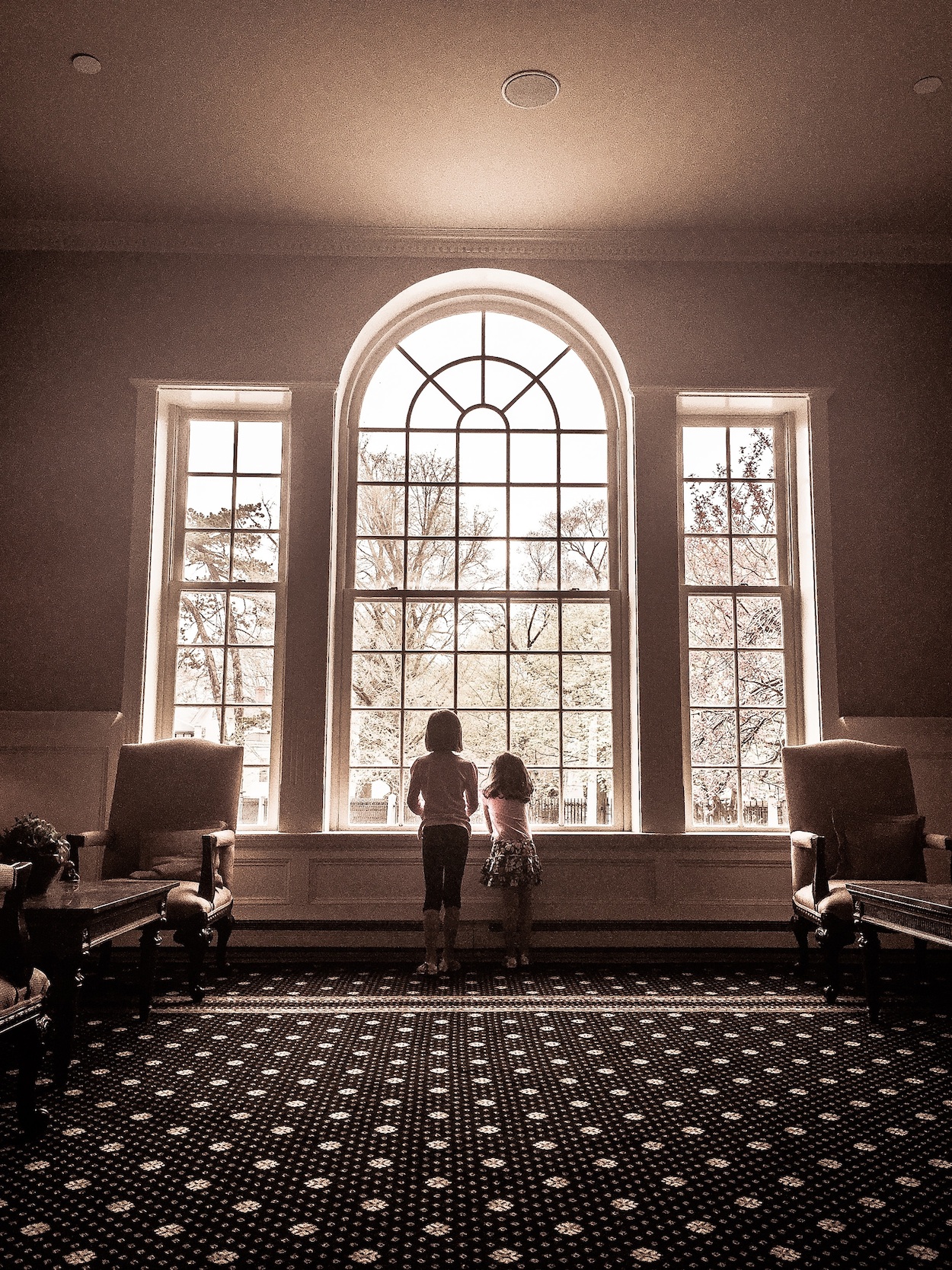 Children looking out the window at Hotel Viking.