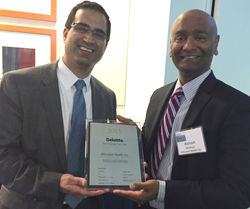 Altruista Health CEO Ashish Kachru (L) and President Ashish Abraham, MD, accept 2015 Deloitte Technology Fast 500 Award