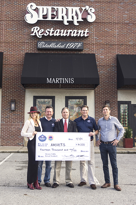 Sperry’s Restaurant owner, Al Thomas, accepts a check on behalf of AMVETS for their continued loyalty and support of Heroes Vodka.