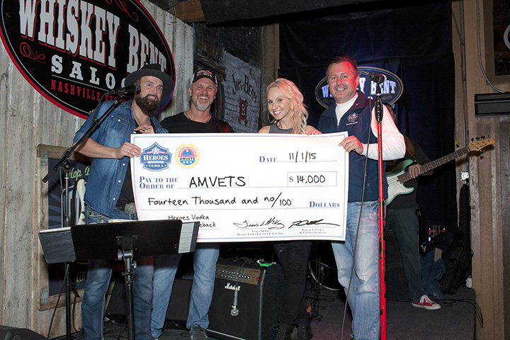 Country Music Artist and Marine Veteran Stephen Cochran accepts a $14,000 check on behalf of AMVETS, at Whiskey Bent Saloon.