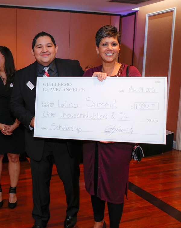 Guiillermo Chavez-Angeles donates $1000 to the Latino Summit, accepted by Harper College Recruiting Specialist and Latino Summit Event organizer Juanita Bassler.