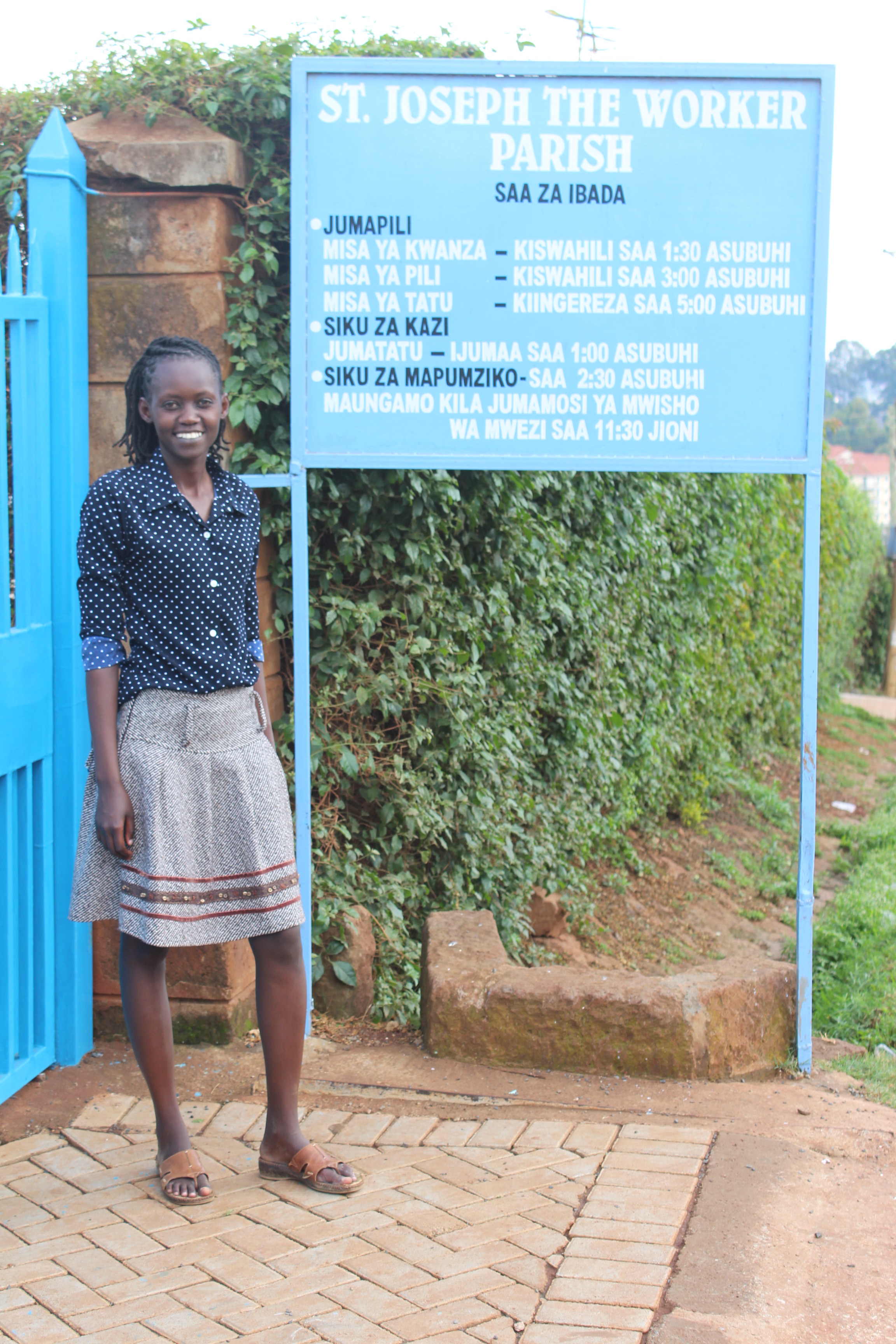 Jacinta Wanjiku, Unbound staff member in Nairobi, stands outside the church where the papal Mass will take place.