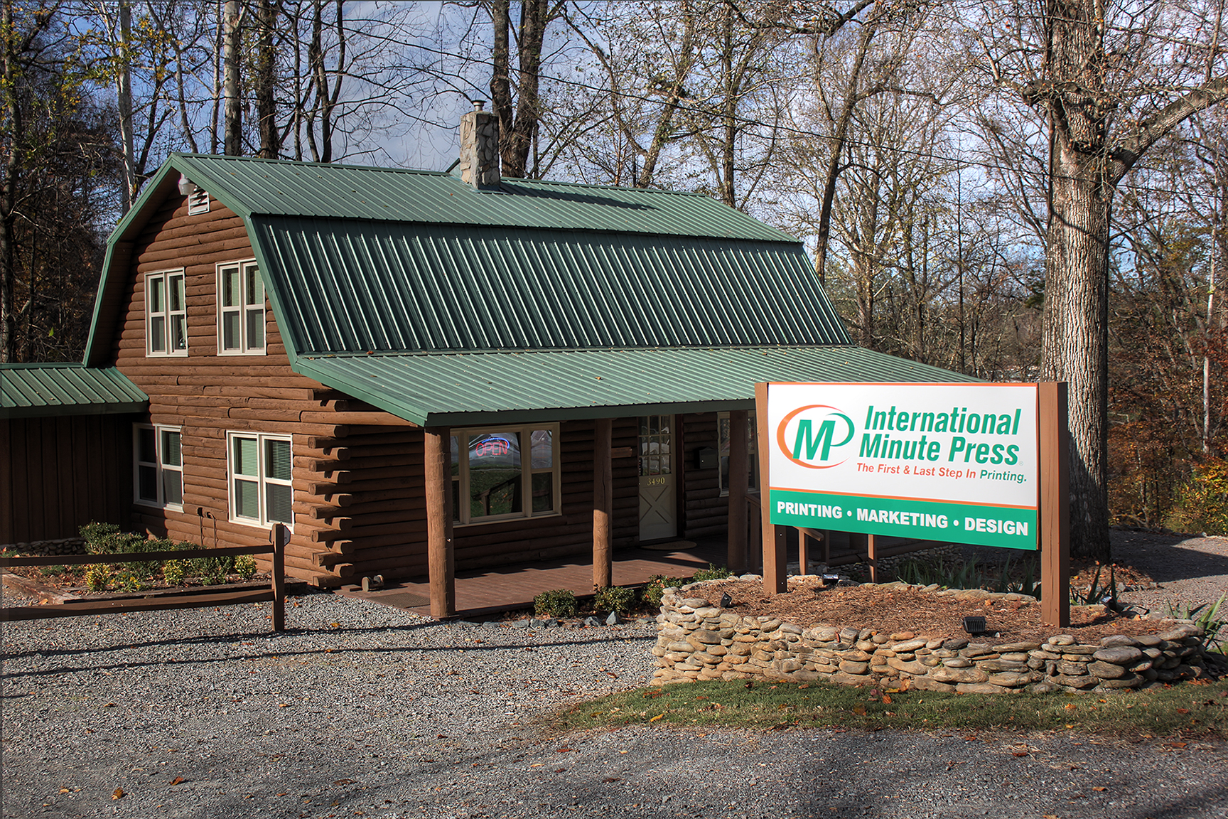 Kelly Boviall's  newly relocated and renovated International Minute Press franchise location with unique log cabin design in Winstom-Salem, North Carolina