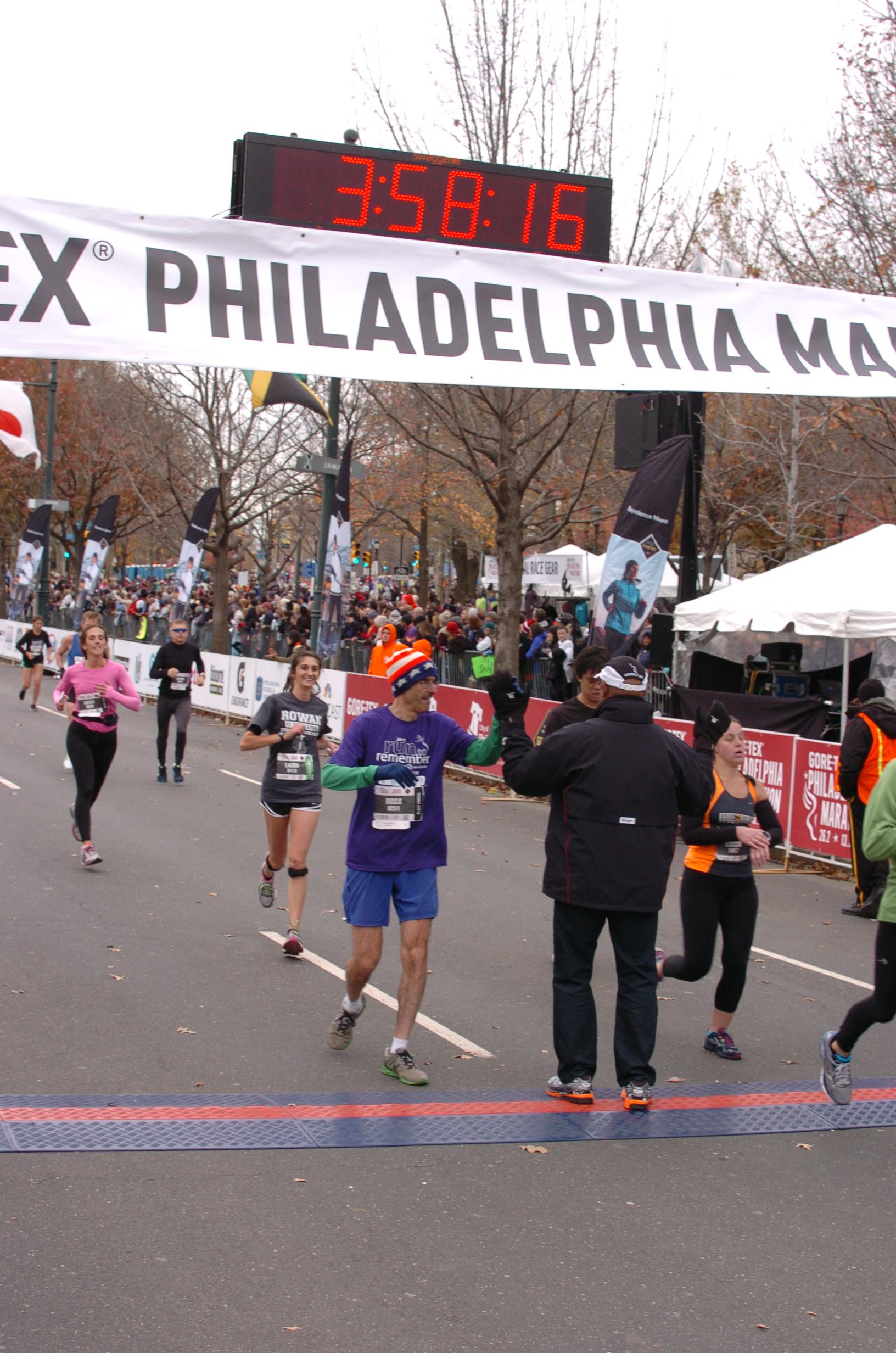 Author & filmmaker Ross Schriftman crosses the finish line of the Philadelphia Marathon