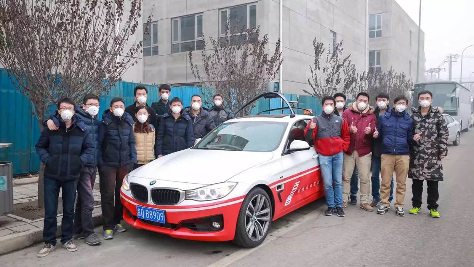 Baidu team gathers around autonomous vehicle, a modified BMW 3 Series