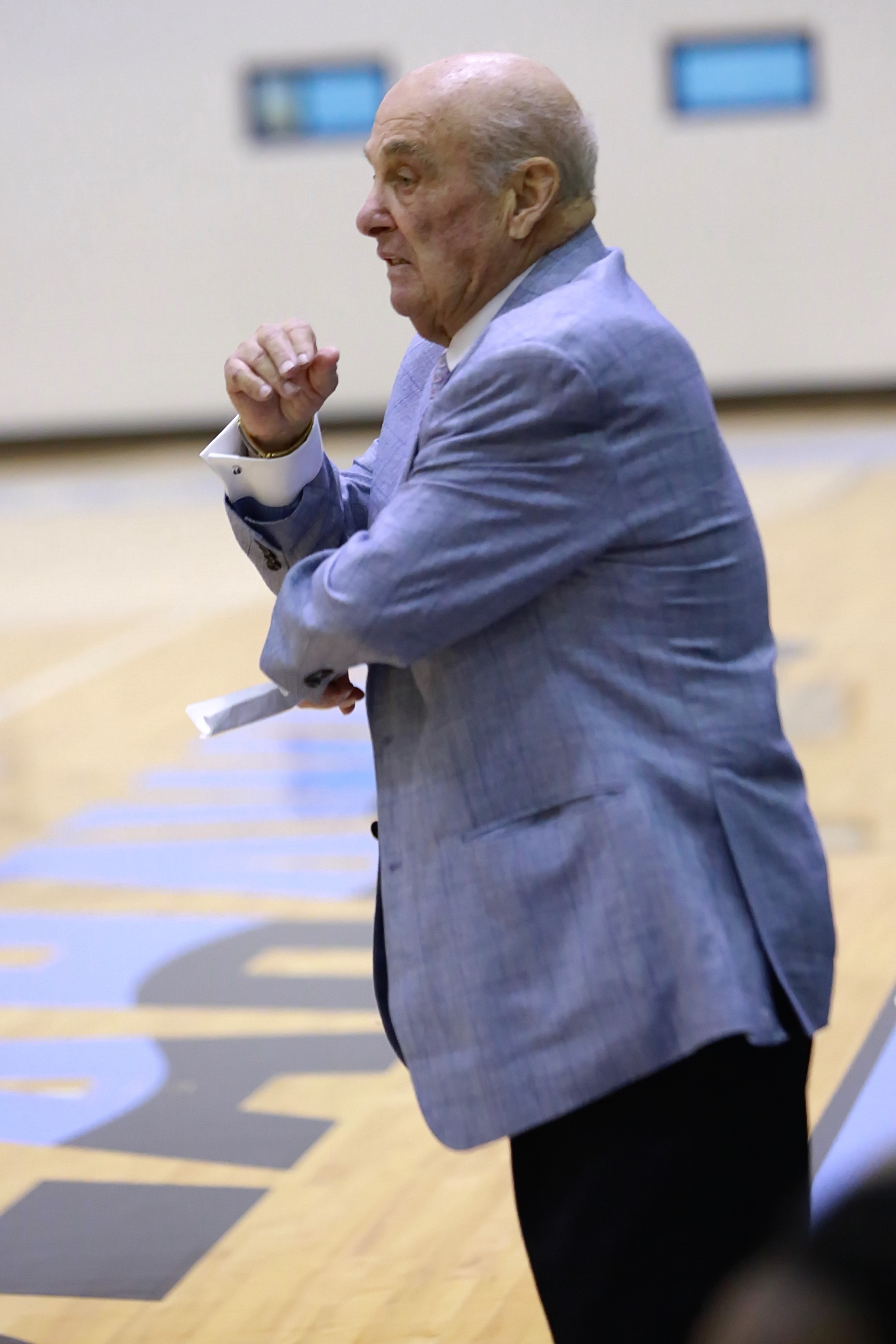Keiser University Coach, Rollie Massimino, standing on the sidelines.