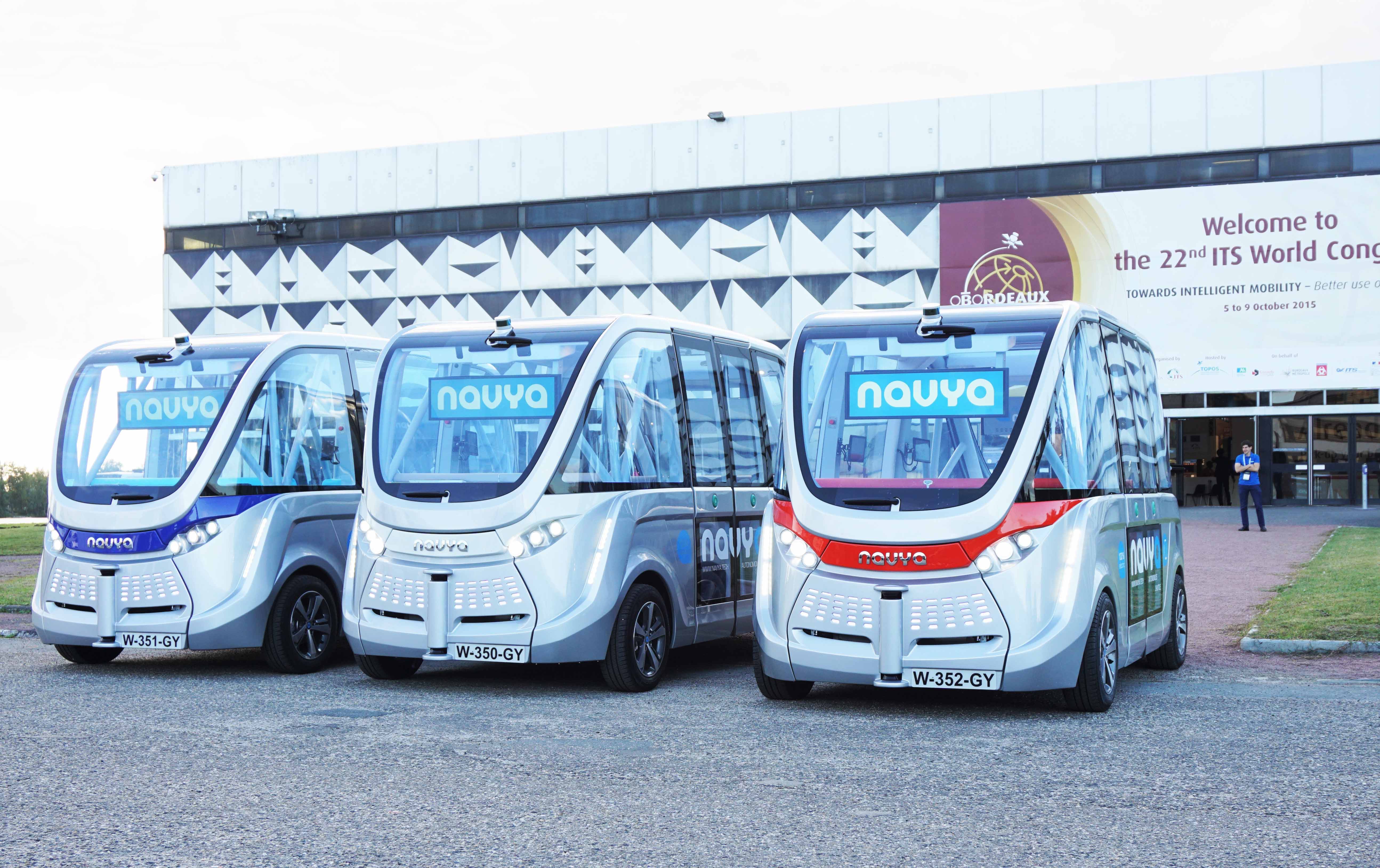 Three members of NAVYA's fleet of driverless electric ARMA shuttles
