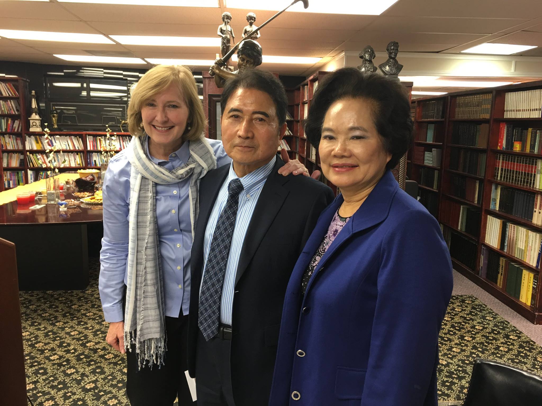 At a her book launch event at the Asian Herald Library in Charlotte, author of The Blu Phenomenon, Catherine Pike Plough, presented her book to library founders and Asian community leaders the Chuns.